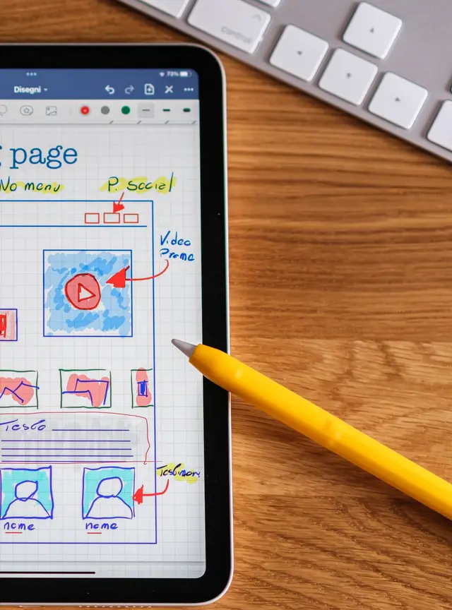A tablet showing a hand-sketched design of an app screen.