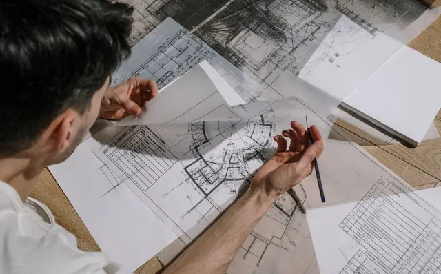 Architect reviewing technical drawings on a table