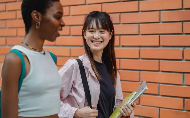 Students talking together in a campus corridor