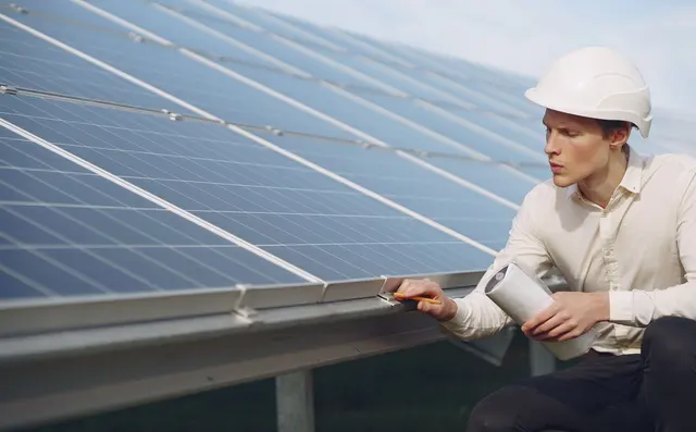 Technician inspecting a wind turbine