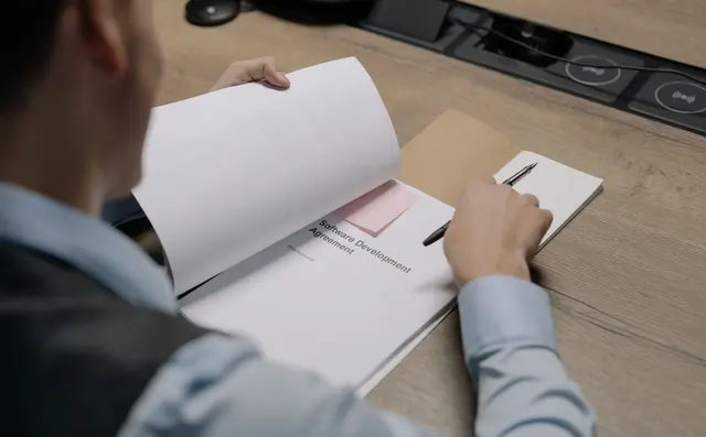 Office worker processing paperwork at a desk