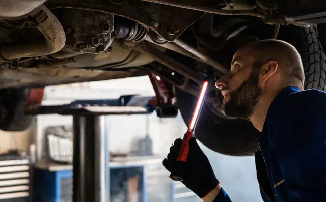 Assessor inspecting damage to a vehicle
