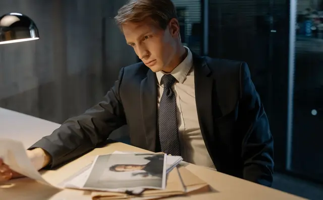 Investigator examining documents with a magnifier