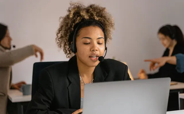 Call centre agent with a headset in an office
