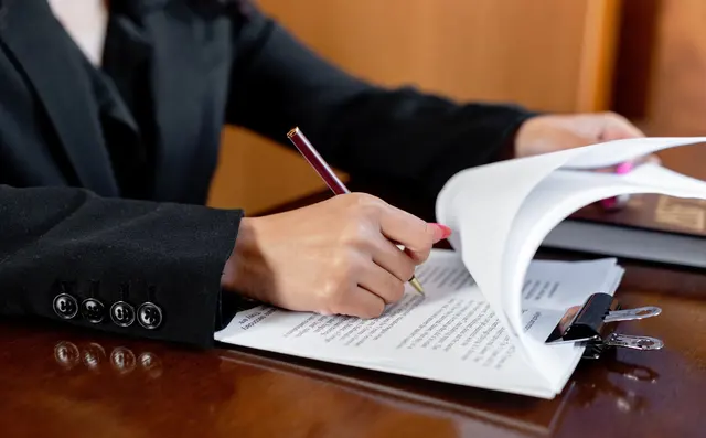 Lawyer reviewing a contract with a pen
