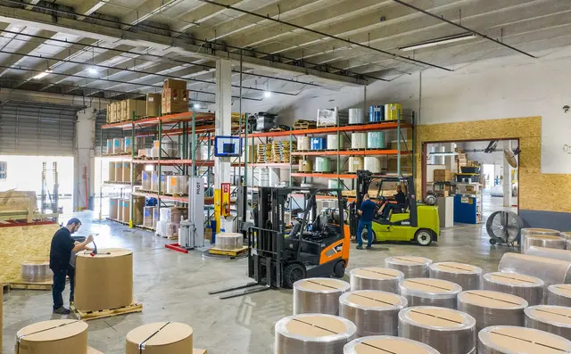 Forklift moving pallets in a warehouse
