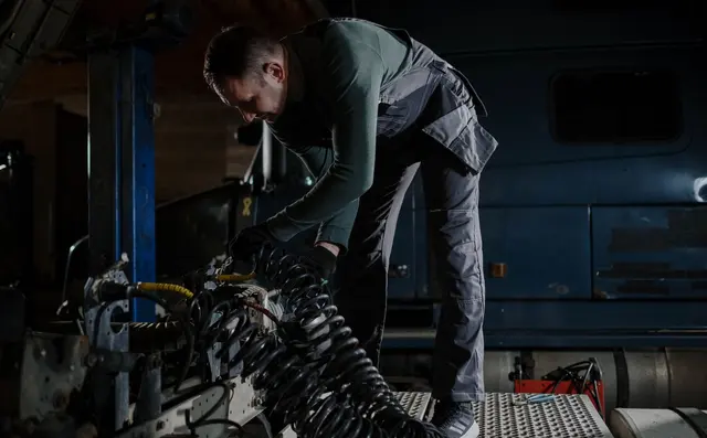 Mechanic servicing a truck in a workshop