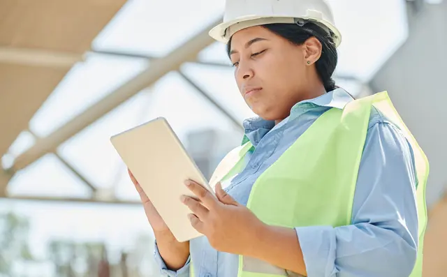 Supervisor with a tablet on a factory floor