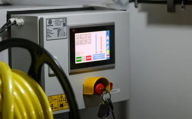 Industrial control panel screens on a factory floor
