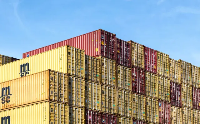 Shipping containers stacked in a port yard