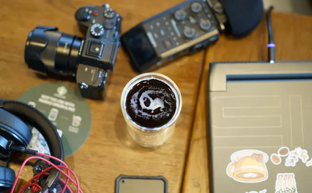 Content creator at a desk with a camera setup