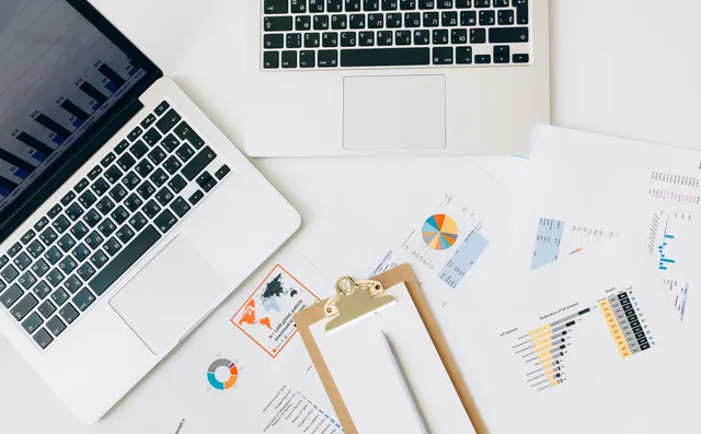 Analytics graphs open on a laptop at a desk
