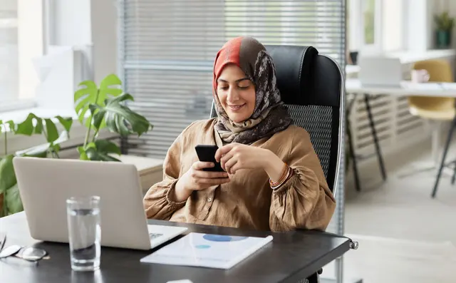 Person answering messages on a phone in an office