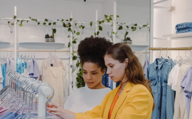 Customer browsing a clothing rail in a store