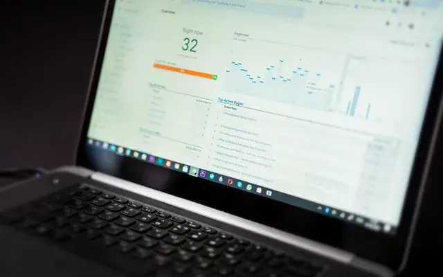 A laptop dashboard showing a single headline figure above the charts