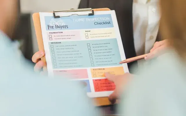 Hands reviewing a printed checklist, criteria agreed before the work starts
