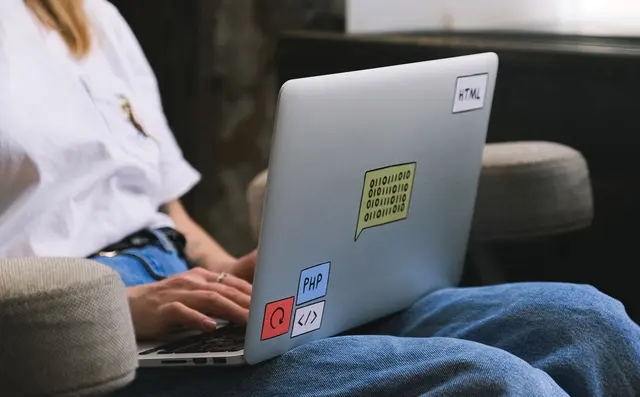 Someone working on code on a laptop