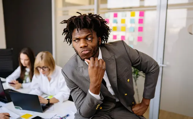 Someone thinking at a table in an office