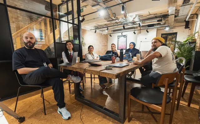 A team meeting around a long table in an office
