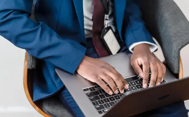 Someone working through email on a laptop