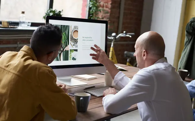 A colleague explaining a spreadsheet to a new team member