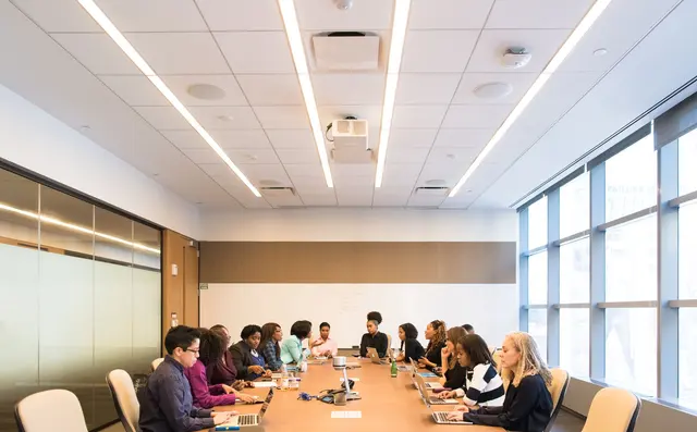 A large team meeting in a boardroom