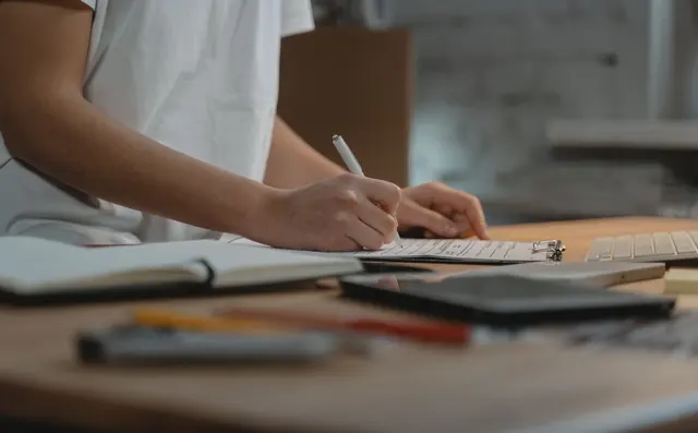 A person checking a document by hand