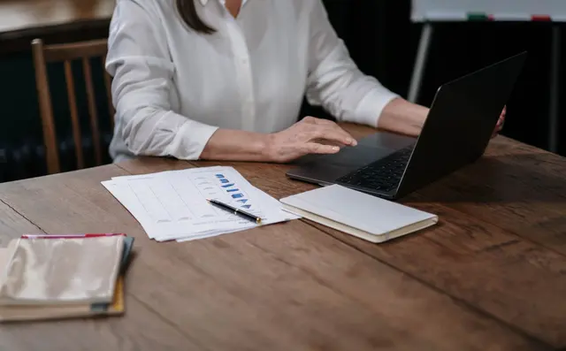 A person working through data on a laptop