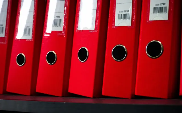 Shelves of binders and technical documents in an archive