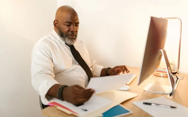 A security officer reviewing access logs on a monitor