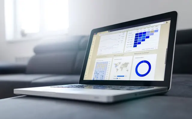 A laptop showing a dashboard with charts
