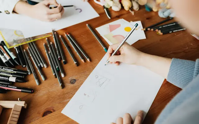 A designer sketching layouts on paper