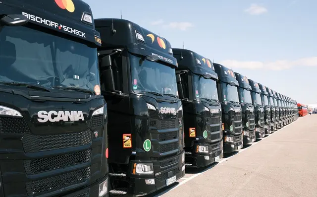 A row of Scania tractor units lined up at a depot
