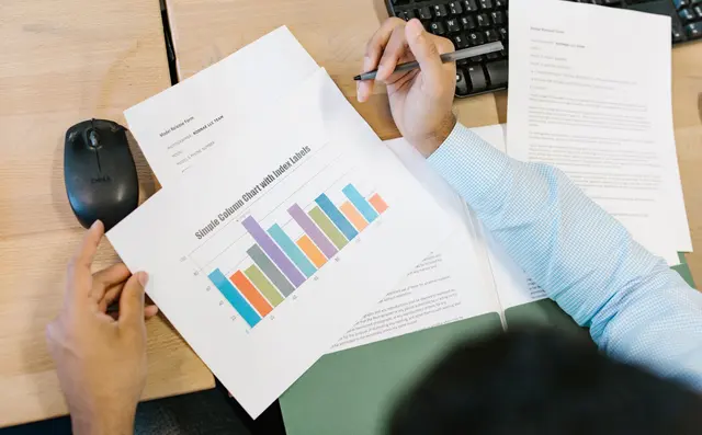 A worker reviewing a chart of results