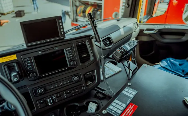 The dashboard of a European truck cab with a mounted screen