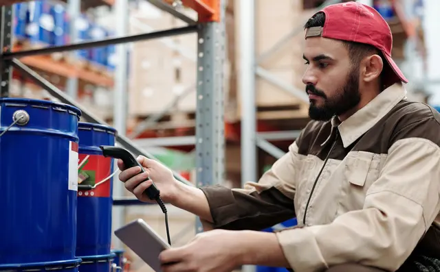 A warehouse worker scanning a barcode with a handheld